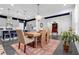 Open-concept living space with dining table, modern lighting, and open kitchen at 2829 Red Alder Blvd, Ocoee, FL 34761