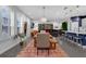 Open-concept living space with dining table, modern lighting, hardwood floors, and comfortable seating area at 2829 Red Alder Blvd, Ocoee, FL 34761