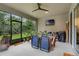 Relaxing screened patio has ample seating, a dining area, and television for entertainment at 2829 Red Alder Blvd, Ocoee, FL 34761