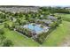 Aerial view of community pool, clubhouse, and green spaces showcasing amenities at 2829 Red Alder Blvd, Ocoee, FL 34761