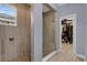 Modern shower with tiled walls and a glass enclosure, leading to a walk-in closet at 2829 Red Alder Blvd, Ocoee, FL 34761