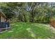 Expansive backyard featuring lush greenery and shade trees, providing a serene and private outdoor space for relaxation at 2843 Grove Dr, Sanford, FL 32773