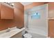 Well-lit bathroom equipped with essential fixtures, including a sink, mirror, toilet, and a bathtub-shower combo at 2843 Grove Dr, Sanford, FL 32773