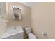 A functional bathroom featuring a classic vanity with sink, a clean toilet, and a well-lit mirror, ensuring comfort and practicality at 2843 Grove Dr, Sanford, FL 32773