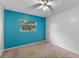 A bright bedroom featuring an accent wall, natural light streaming through the window and carpet flooring at 2843 Grove Dr, Sanford, FL 32773
