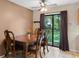 Charming dining area featuring a classic wood table, chairs, and sliding door to the backyard at 2843 Grove Dr, Sanford, FL 32773
