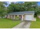 Inviting single-story home featuring a stucco facade, arched entry, and attached one-car garage at 2843 Grove Dr, Sanford, FL 32773