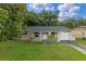 Cozy one-story home with stucco exterior, arched entry, and an attached one-car garage at 2843 Grove Dr, Sanford, FL 32773
