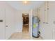 Practical utility area with tiled floor and visible water heater, offering essential home systems and potential storage solutions at 2843 Grove Dr, Sanford, FL 32773