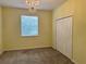 Cozy bedroom with neutral carpet, chandelier, and a large window at 3321 Wilshire Way Rd # 6, Orlando, FL 32829