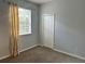 Comfortable bedroom with a large window, closet, and neutral carpet at 3321 Wilshire Way Rd # 6, Orlando, FL 32829