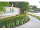 Inviting community entrance with beautifully landscaped signage and mature palm trees at 3321 Wilshire Way Rd # 6, Orlando, FL 32829