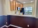 Open kitchen featuring white countertops, appliances, and a breakfast bar at 3321 Wilshire Way Rd # 6, Orlando, FL 32829