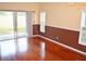 Bright living room showcasing wood floors, sliding glass doors, and natural light at 3321 Wilshire Way Rd # 6, Orlando, FL 32829