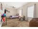 Cozy bedroom with a comfortable bed, sitting chair, and well-lit by two windows and a ceiling fan at 337 Meadow Pointe Dr, Haines City, FL 33844