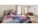 Bright bedroom with a colorful patchwork quilt, beanbag chair, and ample natural light from two windows at 337 Meadow Pointe Dr, Haines City, FL 33844
