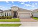 Charming single-story home featuring a brick driveway, neutral stucco, stone accents, and a well-manicured lawn at 337 Meadow Pointe Dr, Haines City, FL 33844