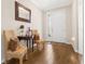 Inviting foyer featuring hardwood floors, decorative seating, and a front door with decorative glass at 337 Meadow Pointe Dr, Haines City, FL 33844