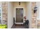 Inviting front door with stone accents, a decorative wreath, and a charming welcome sign, creating a warm entry at 337 Meadow Pointe Dr, Haines City, FL 33844