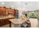 Open kitchen with granite counters, stainless appliances, pendant lighting, and seamless flow to the living area at 337 Meadow Pointe Dr, Haines City, FL 33844