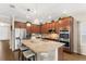 Bright kitchen with granite island, stainless steel appliances, and stylish pendant lighting over breakfast bar at 337 Meadow Pointe Dr, Haines City, FL 33844