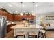 Spacious kitchen with granite countertops, stainless steel appliances, and seamless flow to the living room at 337 Meadow Pointe Dr, Haines City, FL 33844