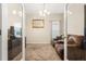 Inviting living room viewed through double doors, featuring neutral colors and a cozy recliner sofa at 337 Meadow Pointe Dr, Haines City, FL 33844