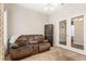 Comfortable living room featuring a plush recliner sofa and double doors with views to the adjacent space at 337 Meadow Pointe Dr, Haines City, FL 33844