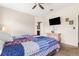 Bright bedroom with a ceiling fan, television, and a view to the en suite bathroom through the doorway at 337 Meadow Pointe Dr, Haines City, FL 33844