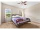 Spacious bedroom with large windows offering natural light, complemented by a ceiling fan at 337 Meadow Pointe Dr, Haines City, FL 33844
