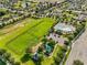 A lush green space features a playground, large field, and a community pool for residents to enjoy at 337 Meadow Pointe Dr, Haines City, FL 33844