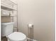 Simple toilet set with shelving for storing linens, providing a functional and organized space at 337 Meadow Pointe Dr, Haines City, FL 33844