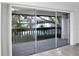 View of the community pool area from the covered balcony with sliding glass doors at 4403 S Semoran Blvd # 3, Orlando, FL 32822
