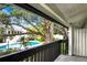 View of the community pool area from the balcony with black metal railings at 4403 S Semoran Blvd # 3, Orlando, FL 32822