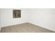 Neutral-toned bedroom featuring tile flooring and a window letting in natural light at 4403 S Semoran Blvd # 3, Orlando, FL 32822