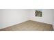 Neutral-toned bedroom featuring tile flooring and a window letting in natural light at 4403 S Semoran Blvd # 3, Orlando, FL 32822