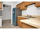 Kitchen sink and counter top with stainless refrigerator and views to living space at 4403 S Semoran Blvd # 3, Orlando, FL 32822