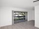 Bright living room featuring tile flooring and sliding glass doors to the outside at 4403 S Semoran Blvd # 3, Orlando, FL 32822
