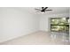 Living room featuring neutral tile floors, ceiling fan, and sliding glass doors at 4403 S Semoran Blvd # 3, Orlando, FL 32822