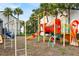 Colorful community playground surrounded by trees and grass for outdoor enjoyment at 4403 S Semoran Blvd # 3, Orlando, FL 32822