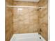 Shower featuring neutral-toned tile surround and white shower tub at 4403 S Semoran Blvd # 3, Orlando, FL 32822
