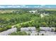 Aerial view showcases the community’s lush landscaping, convenient street access, and proximity to serene lake at 4443 Brook Hollow Cir # 19A, Winter Springs, FL 32708