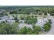 Aerial shot displays the townhome community amidst tree lined streets and nearby green spaces, offering urban tranquility at 4443 Brook Hollow Cir # 19A, Winter Springs, FL 32708
