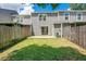 Well-maintained backyard with green grass and wooden fence; great for outdoor entertaining and relaxing at 4443 Brook Hollow Cir # 19A, Winter Springs, FL 32708