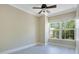 This bedroom features a ceiling fan, light gray laminate flooring and a large window at 4443 Brook Hollow Cir # 19A, Winter Springs, FL 32708