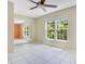 Bright bedroom featuring tiled floors, ceiling fan, and sliding door closet at 4443 Brook Hollow Cir # 19A, Winter Springs, FL 32708