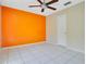 This bedroom features an accent wall, ceiling fan, and tiled flooring at 4443 Brook Hollow Cir # 19A, Winter Springs, FL 32708