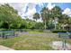 Relaxing community area with inviting picnic tables surrounded by lush green landscaping and tall palm trees at 4443 Brook Hollow Cir # 19A, Winter Springs, FL 32708
