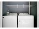 This laundry room includes a washer, dryer, and wire shelving at 4443 Brook Hollow Cir # 19A, Winter Springs, FL 32708