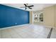Bright living room showcasing a bold accent wall, tile flooring, and large windows at 4443 Brook Hollow Cir # 19A, Winter Springs, FL 32708